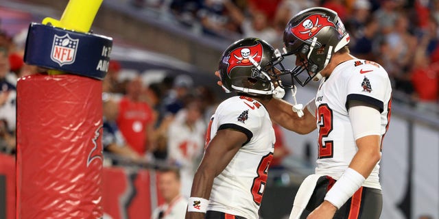 Antonio Brown #81 and Tom Brady #12 of the Tampa Bay Buccaneers celebrate their touchdown during the second quarter against the Dallas Cowboys at Raymond James Stadium on September 9, 2021 in Tampa, Florida. 