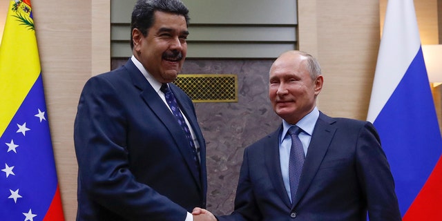 Russian President Vladimir Putin shakes hands with his Venezuelan counterpart Nicolas Maduro