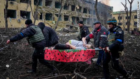 Ukrainian emergency staff and volunteers carry an injured pregnant woman from a maternity hospital damaged by the bombing in Mariupol, Ukraine, Wednesday, March 9, 2022. 