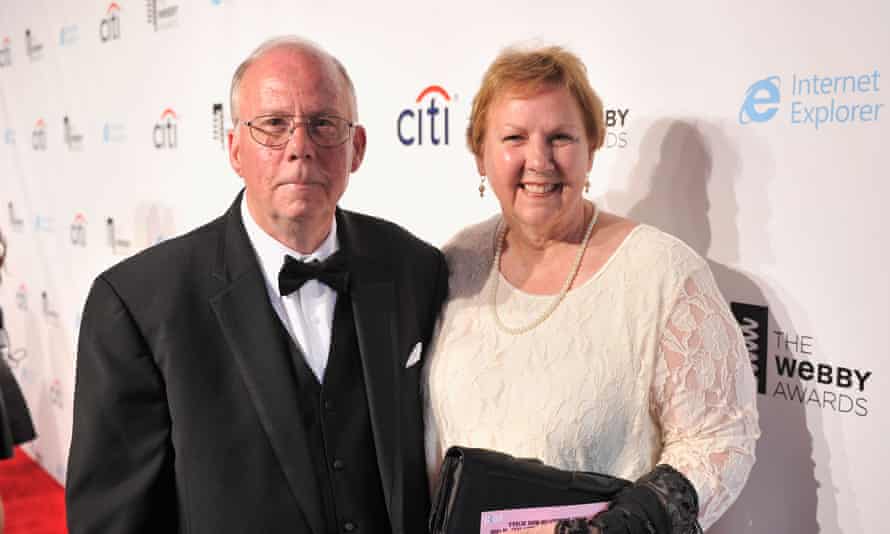 A man and a woman standing in front of the camera
