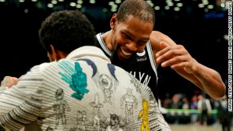 Kevin Durant and Kyrie Irving embrace after the net win over the Knicks.