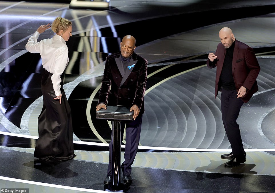Two decades later: John Travolta and Uma Thurman recreate their famous Pulp Fiction scene while performing at the 94th Academy Awards alongside their former actor Samuel L. Jackson on Sunday
