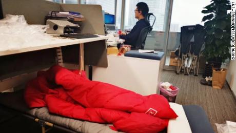 Traders sleep next to their desks as China's financial center is closed