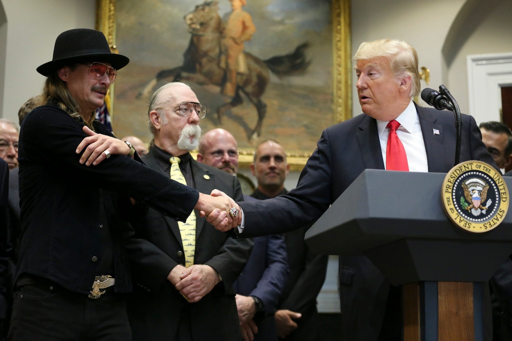US President Donald Trump shakes hands with Kid Rock before signing HR 1551, the Orrin G. Hatch-Bob Goodlatte Music Update Act during a ceremony in the Roosevelt Room of the White House on October 11, 2018. 