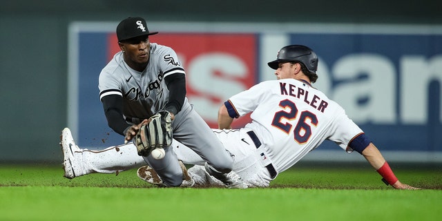 Chicago White Sox's Tim Anderson #7 passes the ball as Max Kepler #26 of the Minnesota Twins slides safely to second base in the seventh inning of the game at Target Field on April 22, 2022 in Minneapolis, Minnesota.  The Twins defeated the White Sox 2-1. 