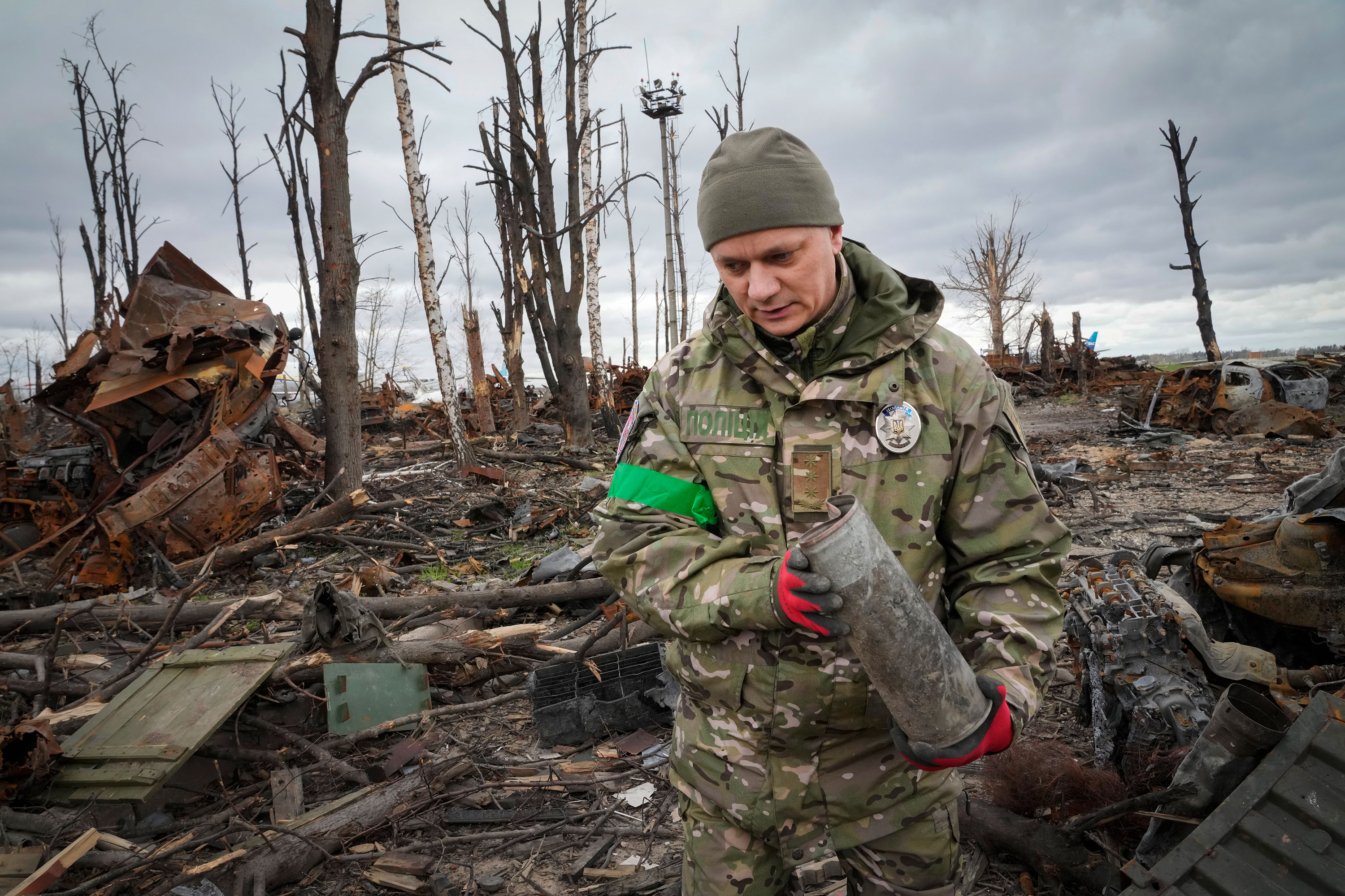 An Interior Ministry explosives expert collects unexploded ordnance in Hostomil, Ukraine, on April 18.