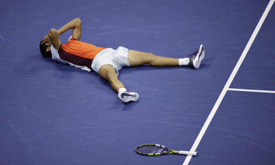 Carlos Alcaraz collapses to the ground after winning