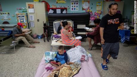 Evacuees are seen in a public school classroom being used as a shelter as Hurricane Fiona and its torrential rain approached in Guayanila, Puerto Rico, on Sunday.