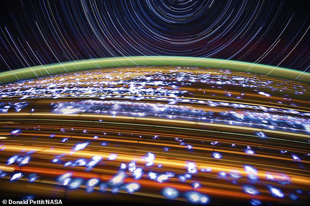 A NASA astronaut captures star trails from space (at the top of the image above) from aboard the International Space Station