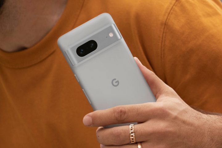 A person holding a white Google Pixel 7 phone.