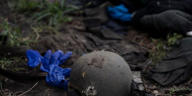 A damaged helmet is seen on the ground at the site where the bodies of four Ukrainian soldiers were found in an area near the border with Russia, in the Kharkiv region, Ukraine, on September 19, 2022.
