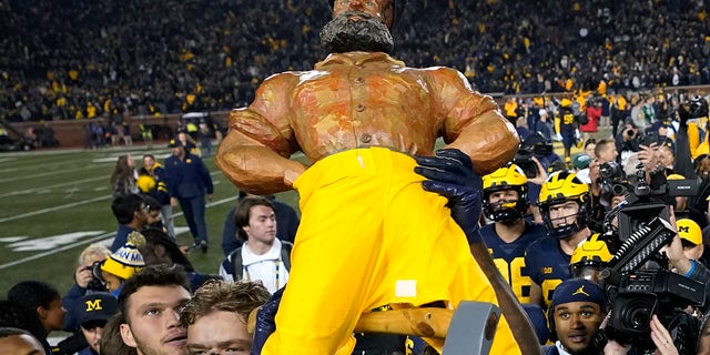 Michigan player Mike Senrestell holds the Paul Bunyan Cup after the game against Michigan State in Ann Arbor, Michigan, on October 29, 2022.
