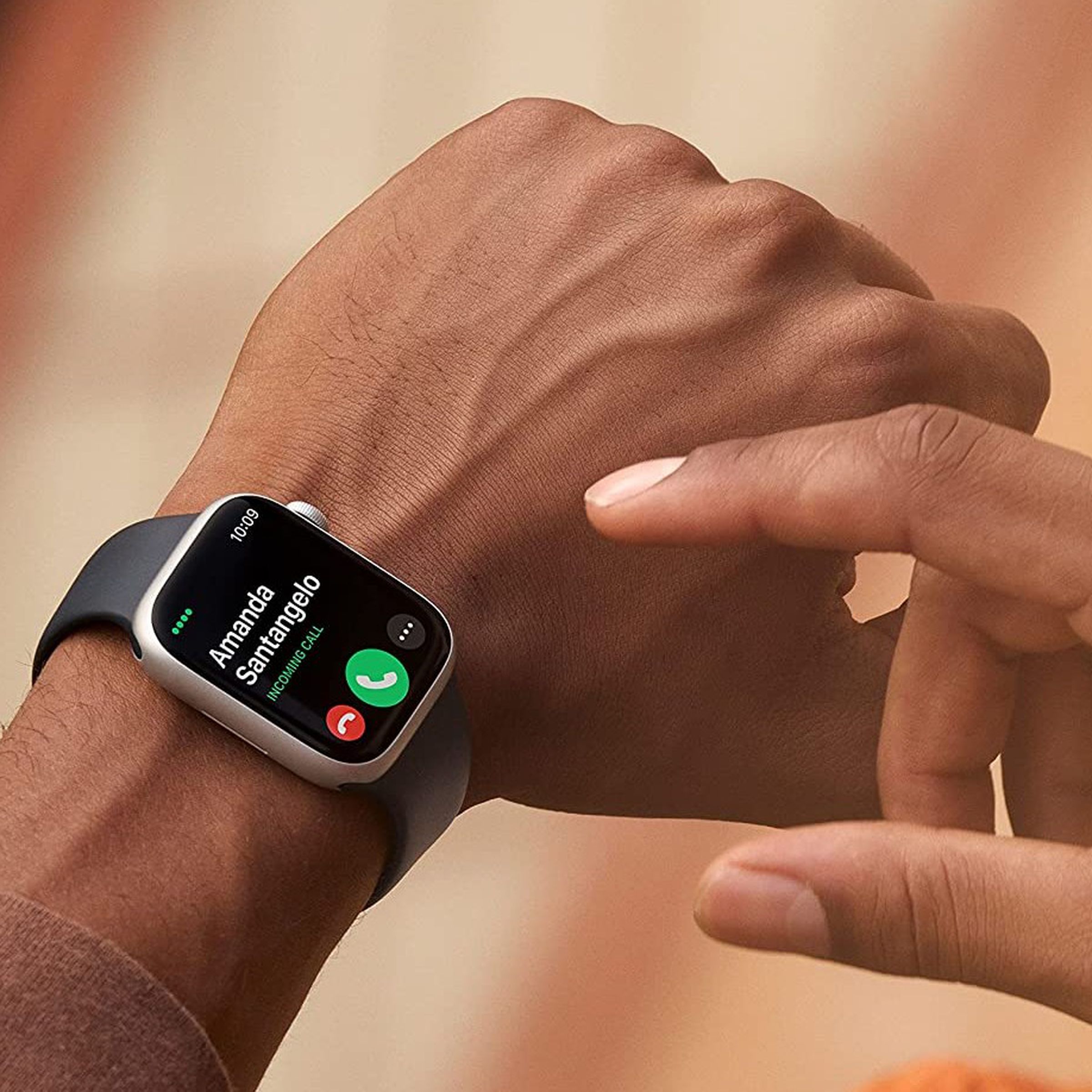 Someone is wearing an Apple Watch Series 8 and is about to tap it.