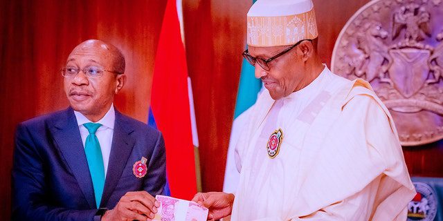 FILE: Godwin Emefele, left, President of the Central Bank of Nigeria (CBN), attends the presentation of new banknotes after Nigerian President Muhammadu Buhari, right, unveiled the newly designed banknotes due to counterfeiting and increasing security problems on November 23, 2022, in Abuja, Nigeria.